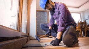 a man completing hardwood flooring installation